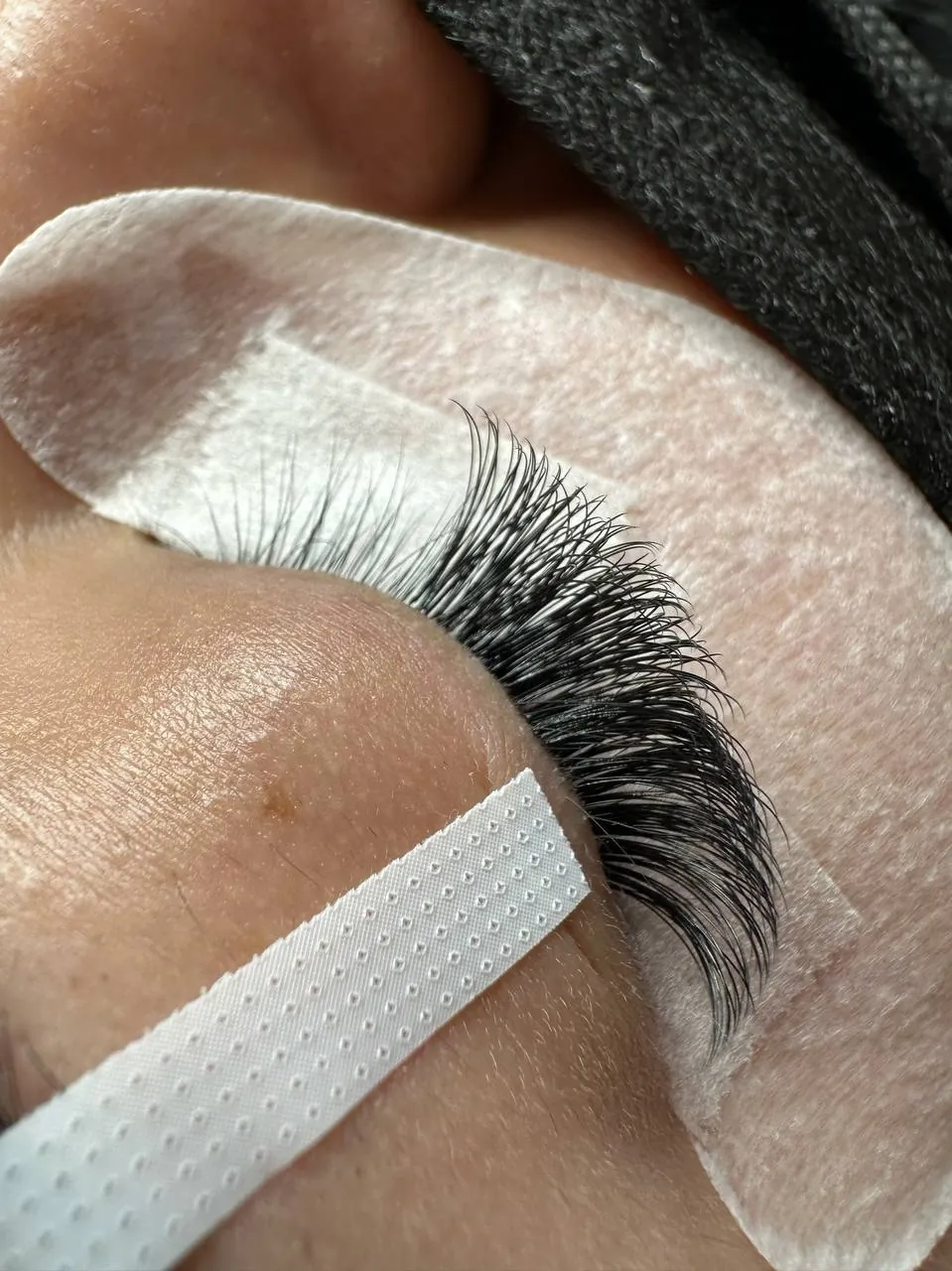 Volume lash extensions being applied at DEEPINLASH, Brooklyn 11223