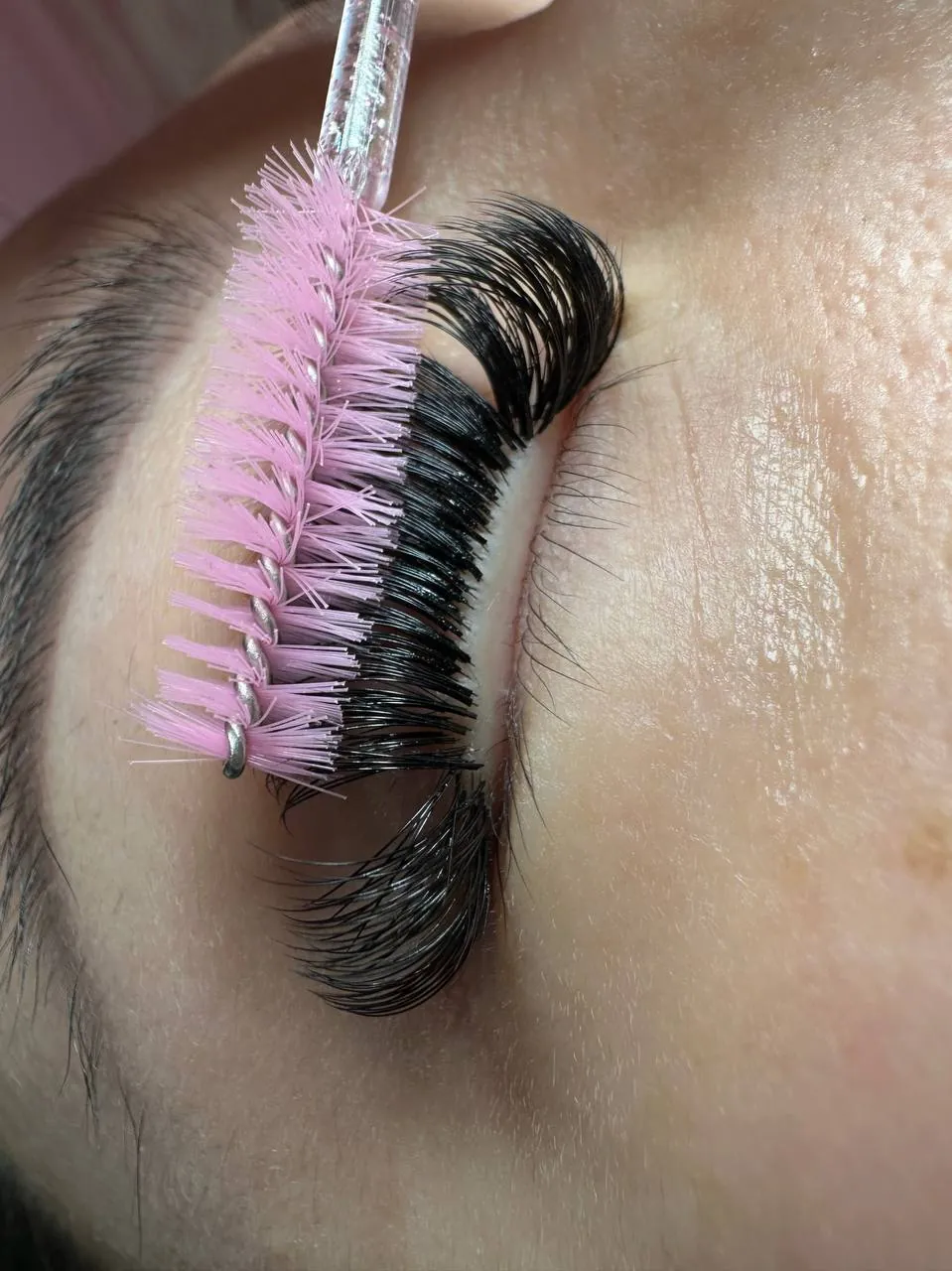 Lash artist building volume fans during an appointment, Gravesend Brooklyn